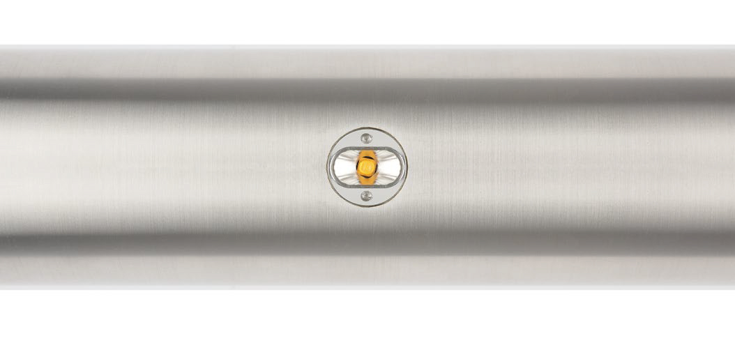 The puck style module light is mounted on the underside of the stair handrails at the Hill Climb in Seattle.