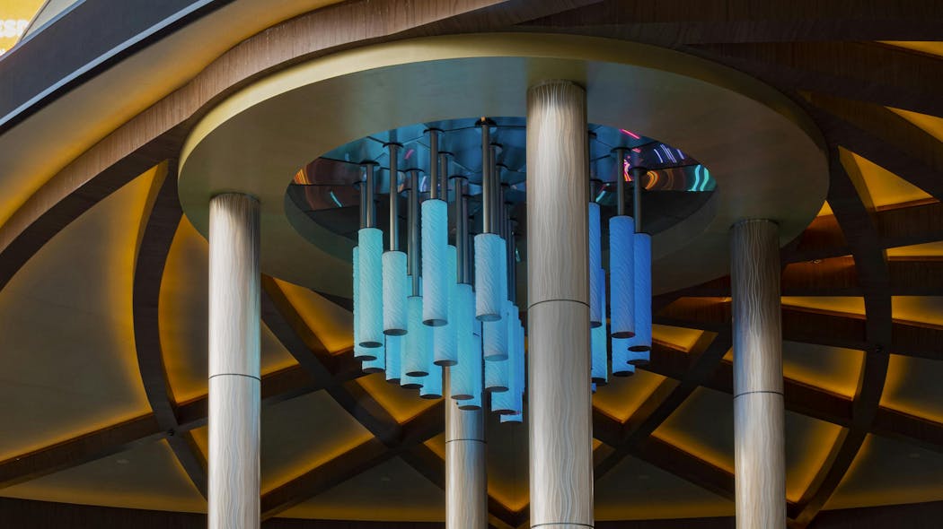 Four 34-foot round columns with light champagne column covers in the Current pattern style flank, and complement, a water feature at the entrance of the Sahara Casino.