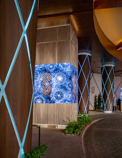 The renovated porte cochere features square columns with Engravings column covers in a light champagne finish and round custom tapering columns with backlit diagonal reveals and a metal column cover in a wood-like Skinz finish. The renovated porte cochere features square columns with Engravings column covers in a light champagne finish and round custom tapering columns with backlit diagonal reveals and a metal column cover in a wood-like Skinz finish.