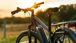 Close-up of e-Bike silhouetted against sunset in the background.