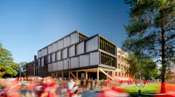 The mass timber and metal addition to the north facade of UNL's historic Architecture Hall was designed to be a material complement to the original red brick, hip-roofed, timber structure, visible here in the background.
