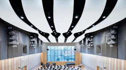 Interior of John Barry Performance Hall showing close-up of glass fiber reinforced acoustic panels in the ceiling and the student chairs and window.