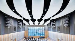 Interior of John Barry Performance Hall showing close-up of glass fiber reinforced acoustic panels in the ceiling and the student chairs and window.