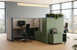 Modern cubicle office space with ample storage in green finish with plants on top.