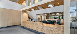Commercial interior with multiple daylighting devices and wood surfaces.