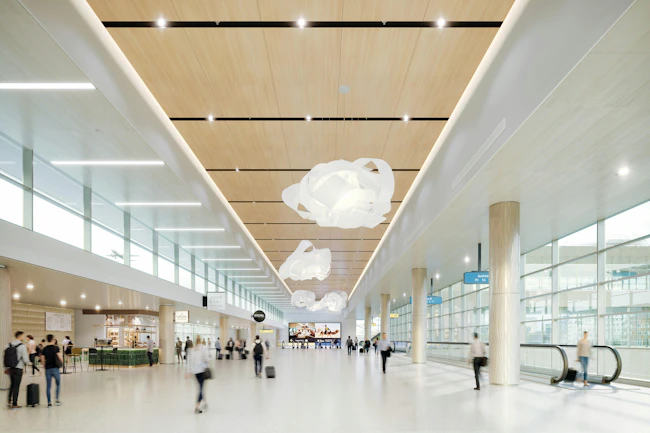 Large-volume interior with wood-look, large-format ceiling tiles that provide both monolithic look and access.