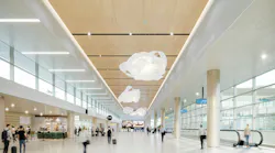 Large-volume interior with wood-look, large-format ceiling tiles that provide both monolithic look and access.