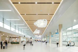 Large-volume interior with wood-look, large-format ceiling tiles that provide both monolithic look and access.