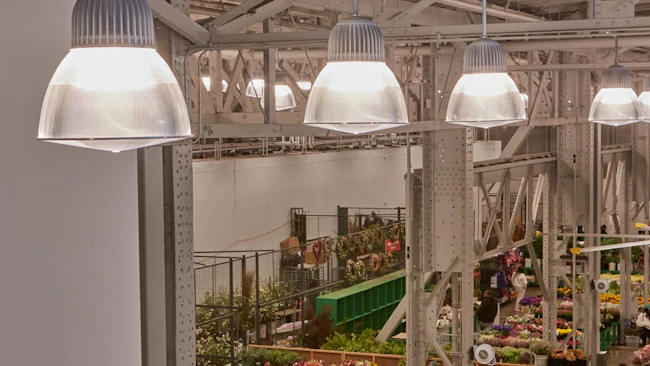 Low bay luminaires with domed tops complement industrial aesthetic at San Francisco Flower Market.