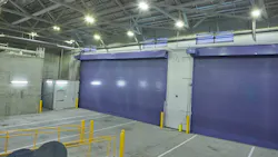 Two purple insulated rolling doors at the exterior loading dock of the San Francisco Flower Market.