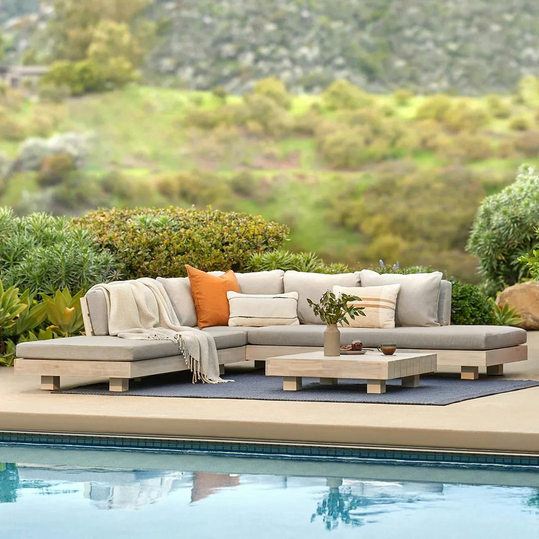 Outdoor poolside lounge-forward sectional in beach sand.