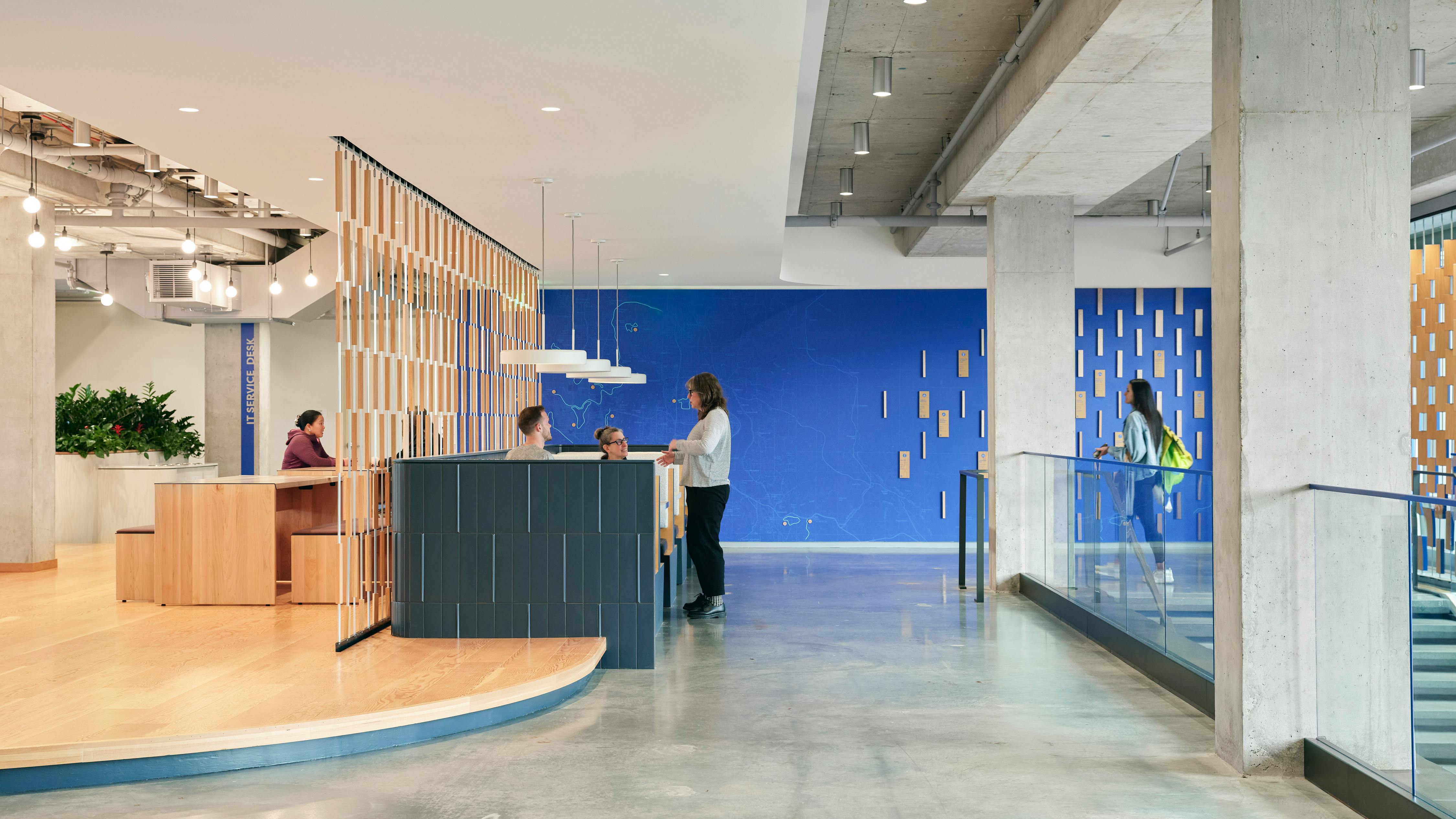 Brooks HQ interior with engineered wood flooring, blue tile, and polished concrete.