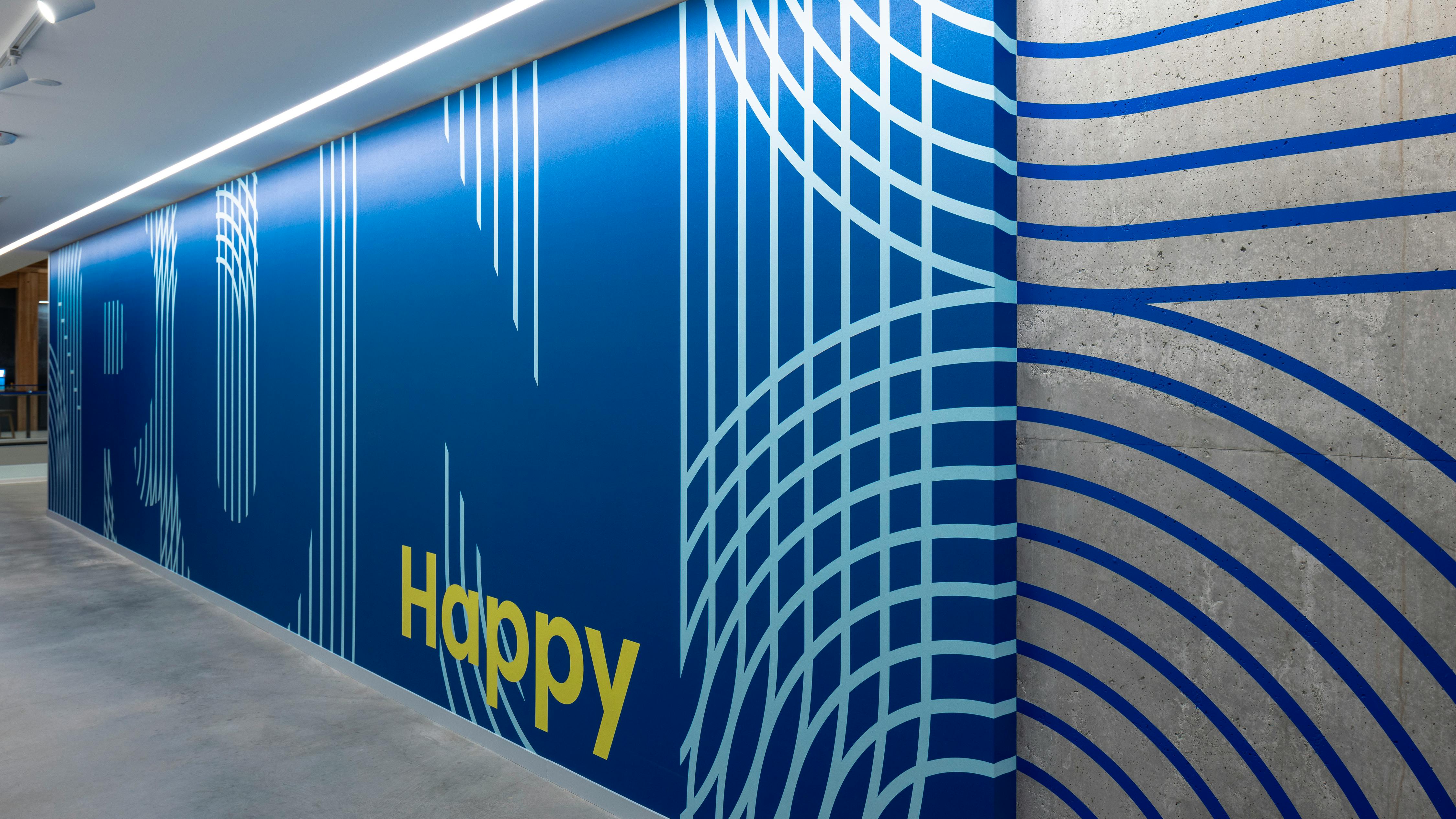 Branded wallcovering in Brooks signature blue from their headquarters.