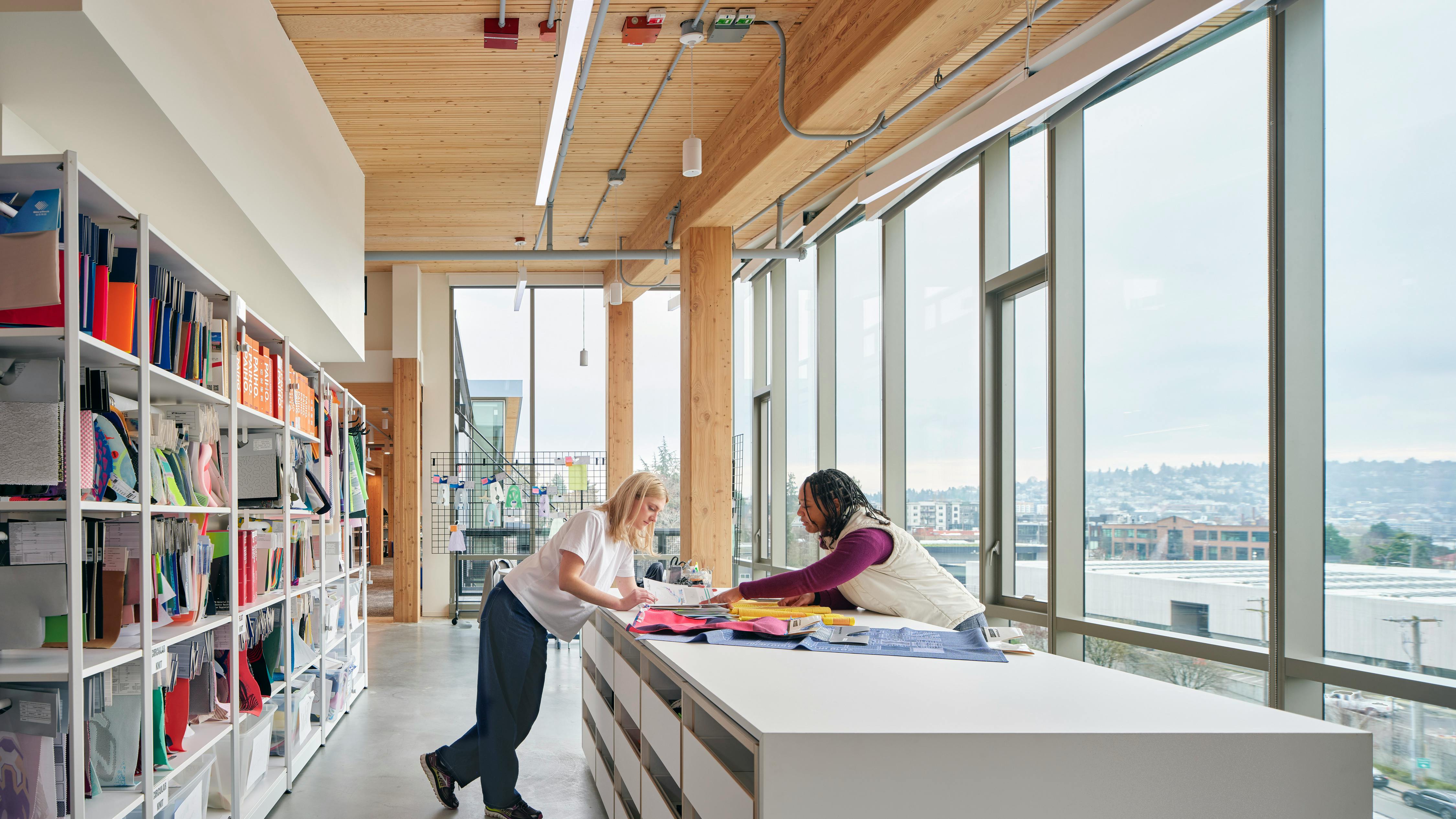 Material lab at Brooks Running headquarters with big windows and tunable white linear luminaire.