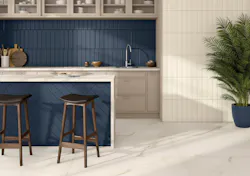 Marine and cream porcelain tile shown on the walls and under the island in the kitchen.