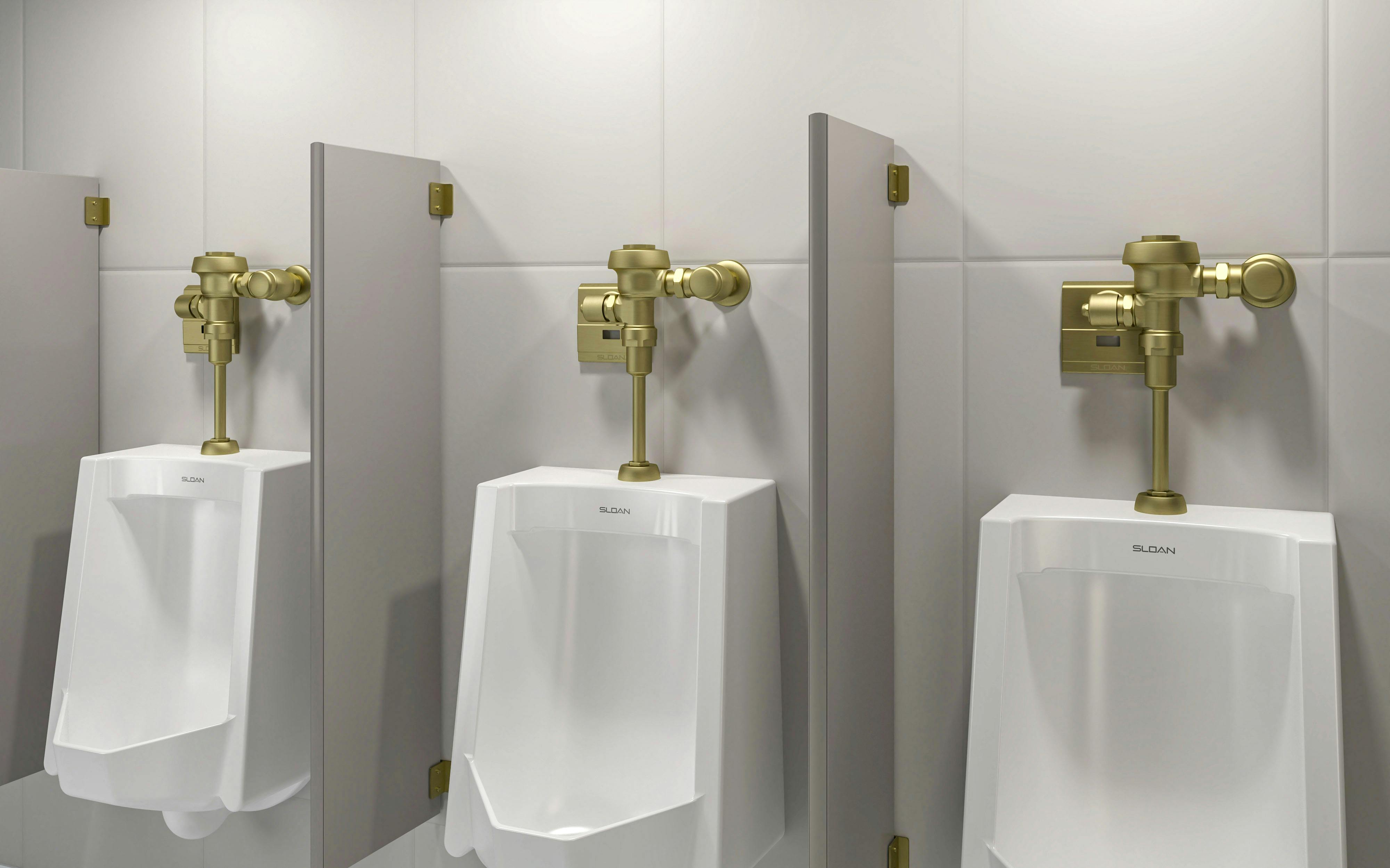 Three urinals with handles in new brushed brass PVD finish.