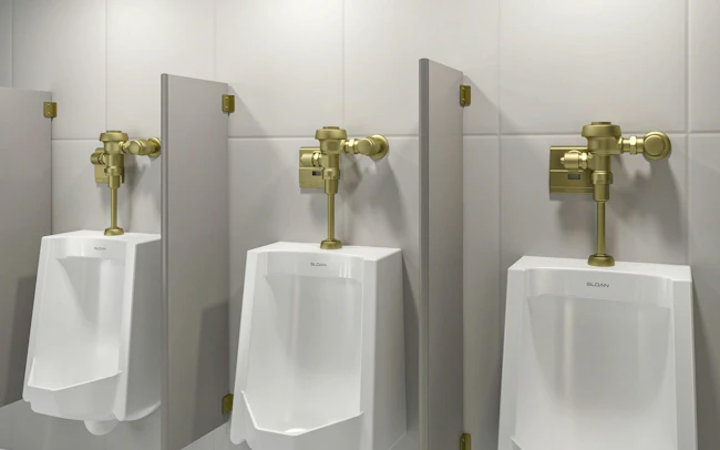 Three urinals with handles in new brushed brass PVD finish.