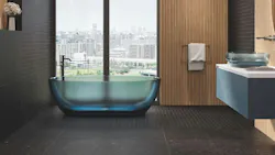 Black tile in bathroom with bathtub by the window.