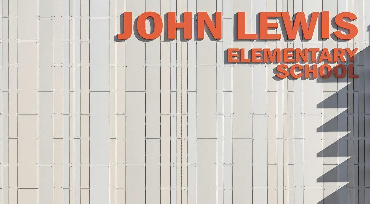 Exterior of John Lewis Elementary School showing oko skin panels in three widths in the color Sahara.